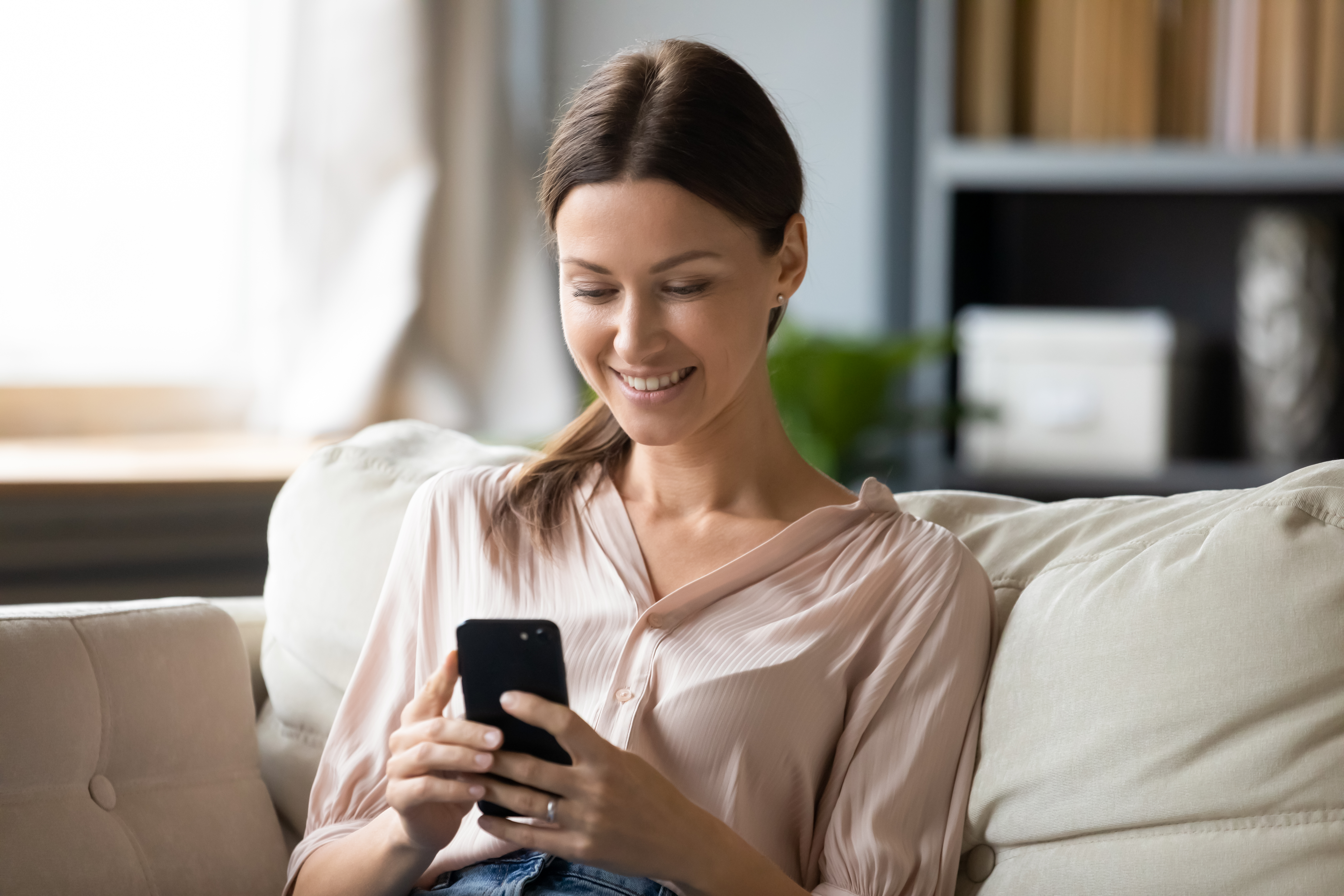 Woman on mobile phone, smiling