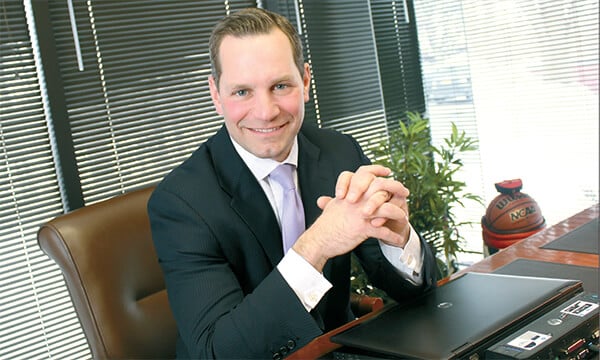 Genesee Regional Bank President Phil Pecora sitting at his desk 